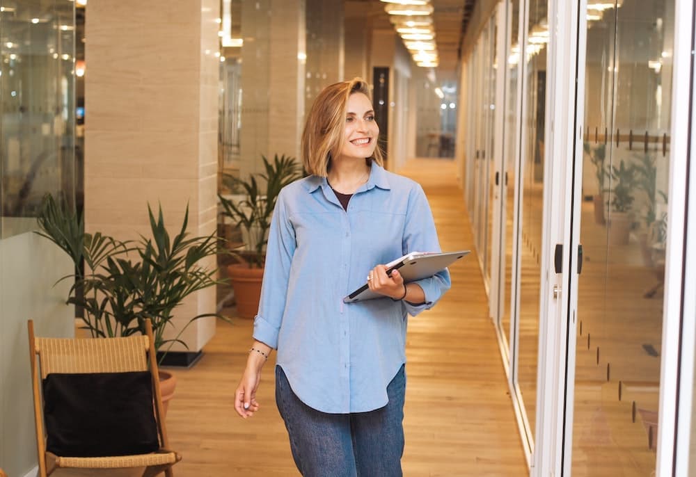 A woman walking through a large office space